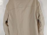 the back of a tan jacket hanging on a white wall