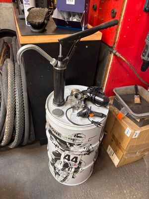 a bike that is sitting on the floor next to a bucket