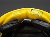 a close up of a helmet with a yellow visor
