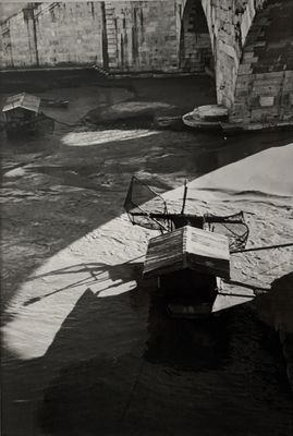 photographie en noir et blanc d'un bateau amarré sur la rive d'une rivière