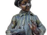a statue of a boy holding a bird in his hand
