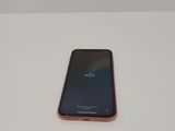 the back of a cell phone sitting on top of a white table
