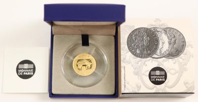 an image of a gold coin in a blue box on a white surface