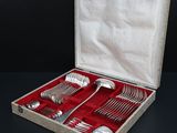 a box with silverware in it on a black surface