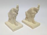 pair of white elephant bookends sitting on a white surface