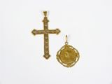 deux croix en or et une pièce d'or sur un fond blanc