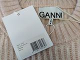 an image of a sweater with a tag that says ganni
