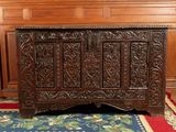 a wooden chest sitting on a rug in a room