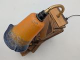 an orange and blue lamp that is on top of a table
