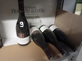 bottles of wine sit in a cardboard box on a shelf