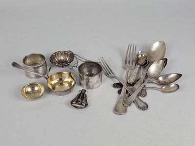 a lot of silverware on a table with spoons and forks