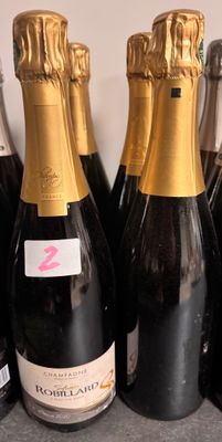 several bottles of champagne are lined up on a counter