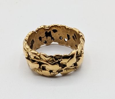 a close up of a gold ring on a white surface