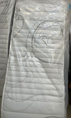 many mattresses stacked on top of each other in a warehouse