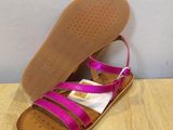 a close up of a pair of pink sandals on a wooden floor
