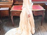 a woman that is standing in a room with a dress on