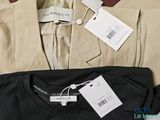 a black shirt and a tan blazer on a table