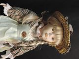 a doll that is wearing a hat and dress