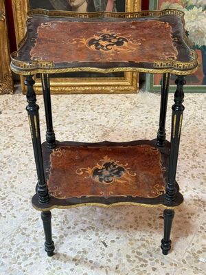 an image of a table with a painting on the wall behind it