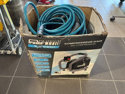 a box that has a hose in it on the floor