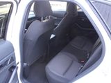 a white car with the door open and the seats down