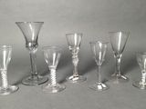 six wine glasses sitting on a table next to each other