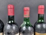 several bottles of wine are lined up on a table