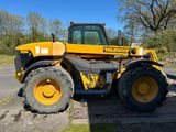 un tracteur jaune garé sur le bord de la route