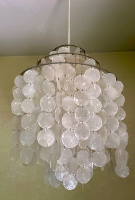 a chandelier made out of plastic bottles hanging from the ceiling