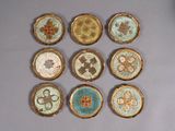 nine small plates with different designs on them on a table