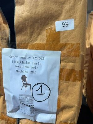 a brown bag with a sticker on it sitting on a chair