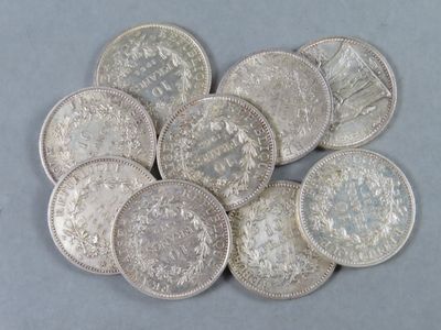 a pile of silver coins sitting on top of a table