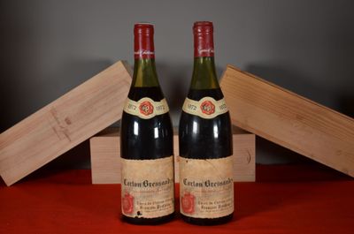 two bottles of wine sitting on top of a table next to a wooden box