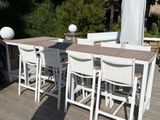 a table and chairs on the deck of a house
