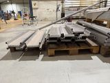 several pieces of steel are stacked on pallets in a warehouse