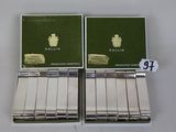 pair of silver business cards with green covers and a silver case