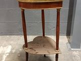 a small wooden table with a shelf on it