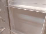 a white refrigerator with its door open in a kitchen