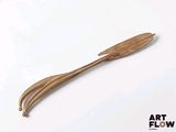 a wooden spoon and fork sitting on a white surface
