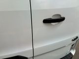 a close up of a car door handle on a white car