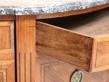a close up of a wooden cabinet with a marble top