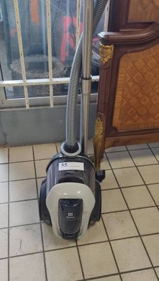 a vacuum that is sitting on the floor in front of a door