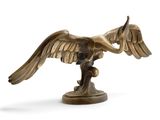 bronze statue of a bird on a branch on a white background