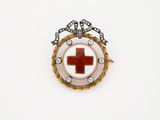 une image représentant une broche en forme de croix rouge sur fond blanc
