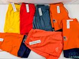 many different colors of shorts on a white surface