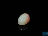 a white oplite in the dark with a black background