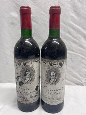 two bottles of red wine sitting on top of a white table