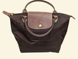 a close up of a brown and brown purse on a white background