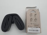 a close up of a pair of black bicycle inner tubes on a white surface