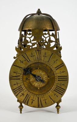 une horloge en or avec des chiffres romains sur le cadran
